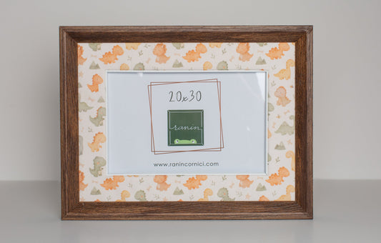 Cornice in legno marrone 20x30 con passepartout in tessuto a tema dinosauri